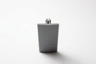 Grey PVC Herzim strip shown end-on, revealing its tapered trapezoid cross-section