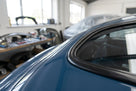 Black trim strip fitted along the roof edge of a blue-grey classic car