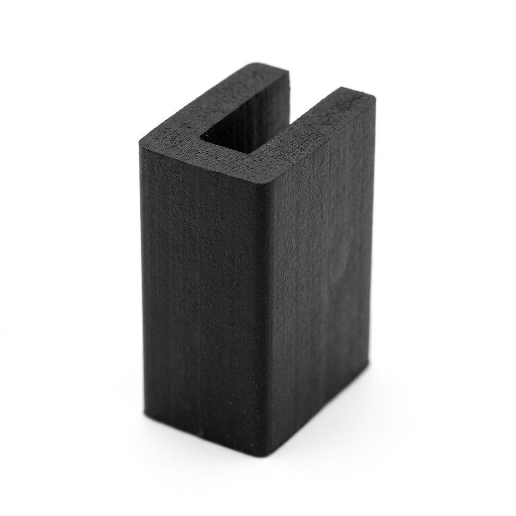 Black EPDM U-channel profile standing upright, plain white background shot of square-ended block