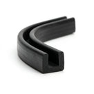 Black rubber U-channel profile coiled, curved length showing square-ended groove
