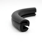 Black S-shaped window rubber seal coiled, curved length showing bulb and open channel