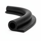 Black hollow P section rubber extrusion bent into a curve, studio shot