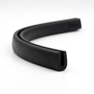 Black rubber U-channel profile coiled, curved length showing rounded groove