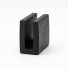 Black EPDM U-channel rubber profile standing upright, plain white background shot