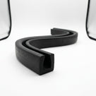 Black rubber square U-channel shown as coiled S-curved length on white background