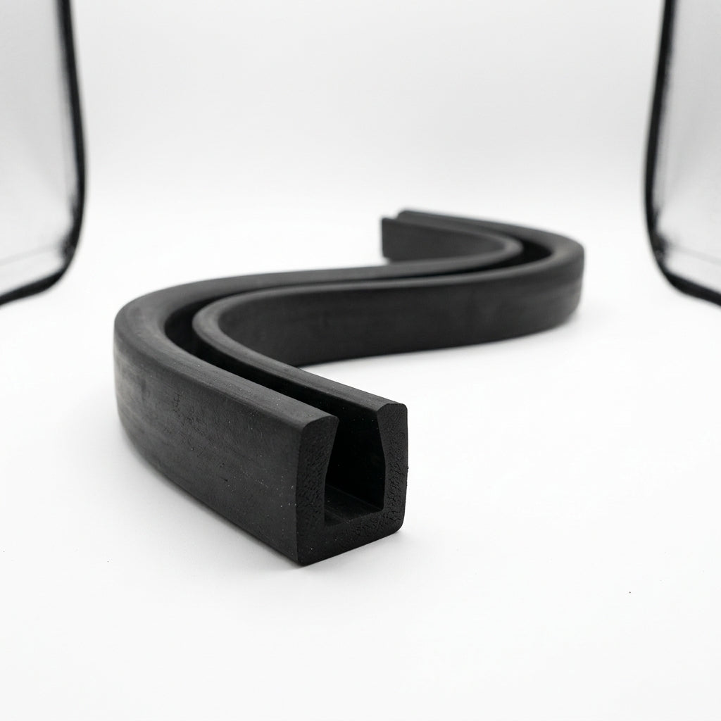 Black rubber square U-channel shown as coiled S-curved length on white background