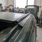 Tadpole seal fitted along the roof edge of a green classic car in a workshop