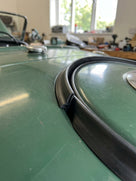 Spare wheel cover seal fitted to the boot lid rim of a green Triumph