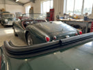 Hard top seal fitted along the roof edge of a green Triumph, garage setting