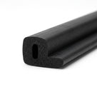 Black sponge rubber seal with side flange, cut end showing hollow bore