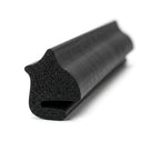 Black sponge rubber section seal with curved lip and hollow bore, angled length