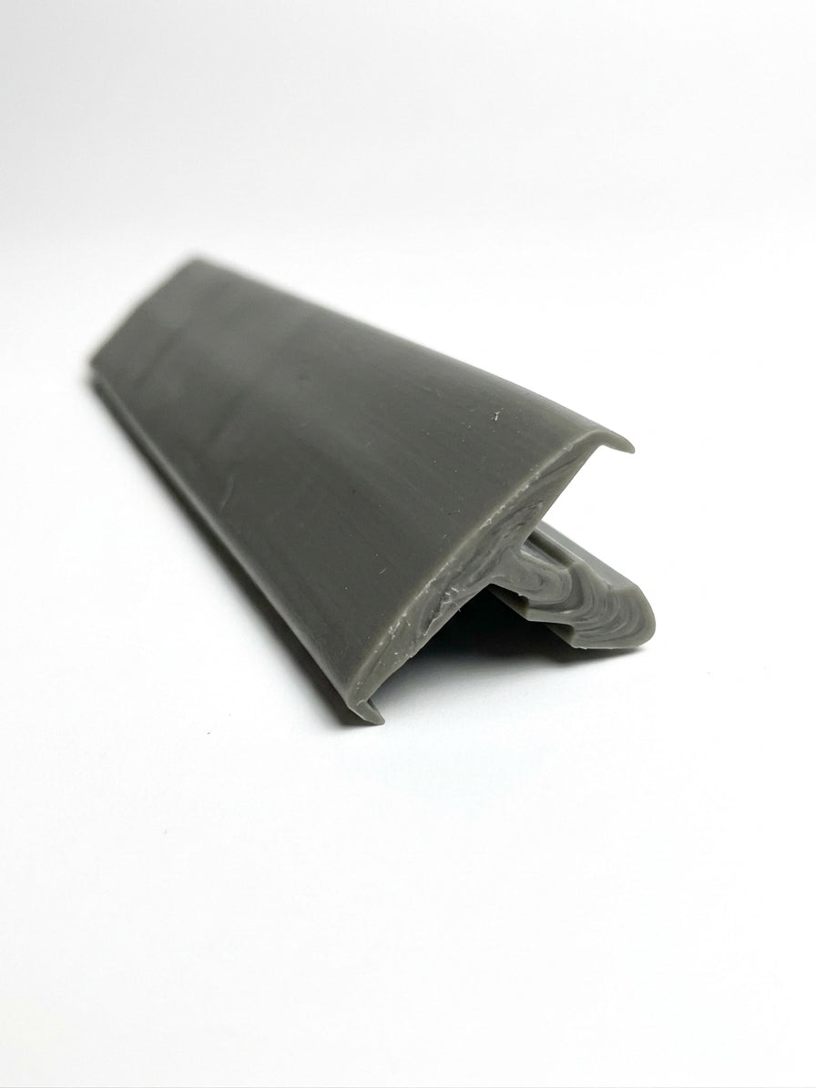 Grey edge trim profile shown at an angle, with a flat lip and moulded foot