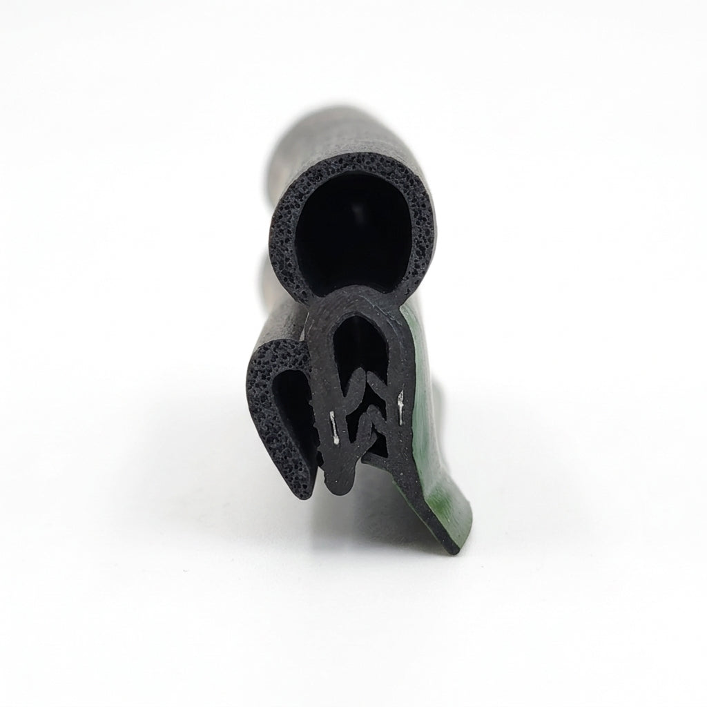 End-on view of black tailgate seal showing its hollow bulb and ribbed fitting fin