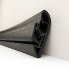 Angled view of black rubber seal length propped against a wall, showing clip end