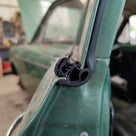 Self-grip seal fitted along a green classic car door frame in a workshop