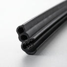 End-on view of black rubber double seal with twin bores and metal grip teeth