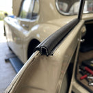 Self-grip rubber seal fitted along a cream classic car's boot edge