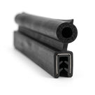 Black rubber edge trim with hollow bulb and metal insert channel, studio shot