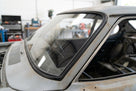 Black windscreen surround fitted around a bare metal Capri's screen, workshop