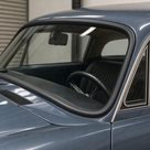 Black windscreen rubber seal fitted around the screen of a grey classic coupe