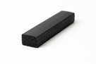 Short rectangular black sponge strip with visible porous cut face