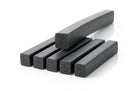 Several square sponge rubber strips stacked, one bent to show flexibility