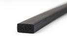 Short rectangular black sponge strip, angled studio shot showing porous end