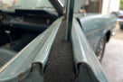 Black felt strip fitted into a classic car's door channel between glass and bodywork