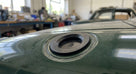 Black rubber fuel filler cap fitted to the bonnet of a green Triumph Stag