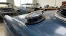 Chrome fuel filler cap fitted to a blue classic car's rear wing