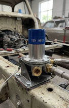 Electronic fuel pump mounted on a chassis rail in an engine bay