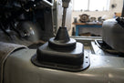 Black rubber gear lever gaiter fitted around the gearstick in a car interior