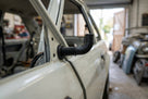 Black door wiring grommet fitted to a white Escort's door aperture