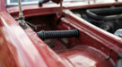Black ribbed aerial grommet fitted through a red car's scuttle panel