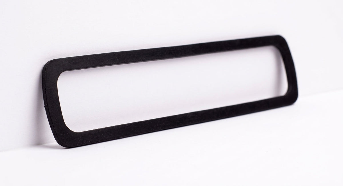 Black rectangular rubber boot seal gasket, studio shot on white background
