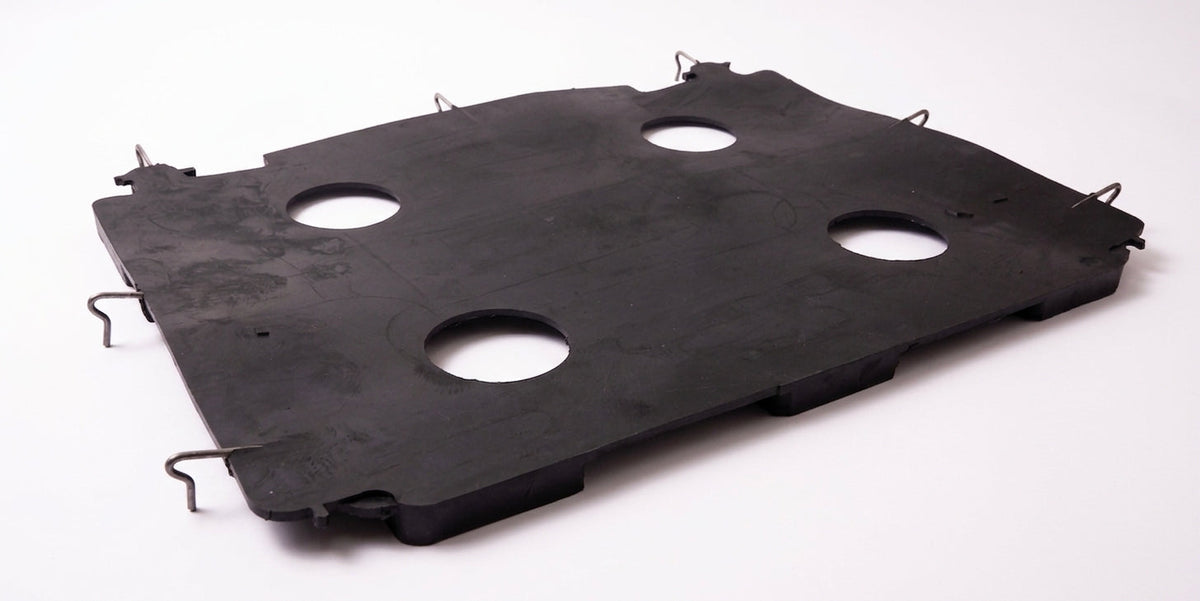 Black seat diaphragm panel with round cutouts and wire clips, studio shot