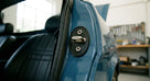 Door striker gasket fitted behind the lock on a blue Triumph's door