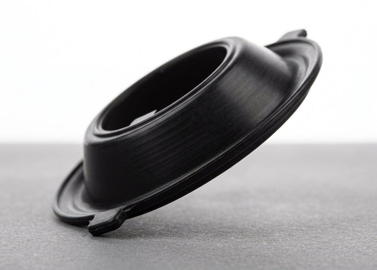 Black rubber carburettor diaphragm, domed profile, studio shot