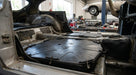 Front seat diaphragm laid into the footwell of a Jaguar E-Type during restoration