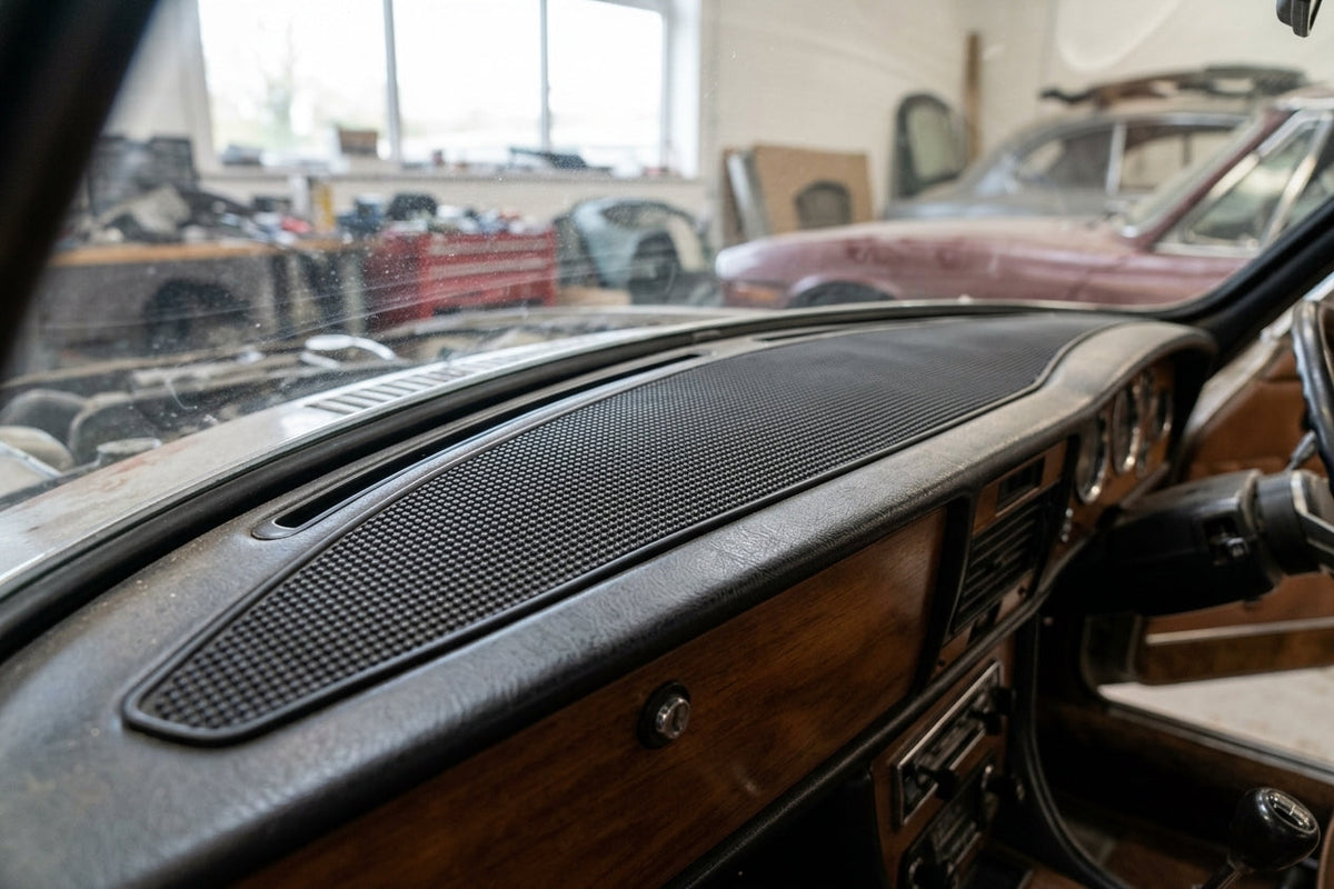 Black textured rubber dashboard pad fitted along the top of a wood-trimmed dashboard