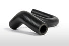 Coiled black ribbed hose with one end curled, studio white background