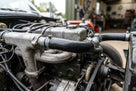 Black hose fitted between inlet manifold and radiator in an engine bay
