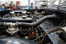 Black heater hose fitted with jubilee clips in a classic Triumph engine bay
