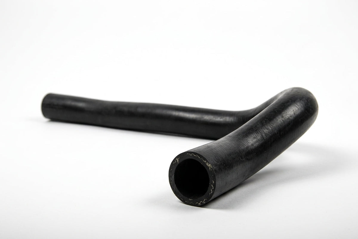 Black radiator bottom hose with gentle bend, studio shot on white