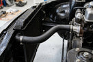 Radiator bottom hose fitted between radiator and engine on a black Triumph TR7