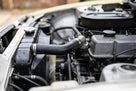 Radiator top hose fitted between radiator and engine on a cream Triumph TR7