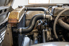 Bottom radiator hose fitted in a classic Triumph's engine bay