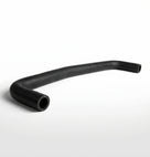 Curved black ribbed heater hose on white background, studio shot