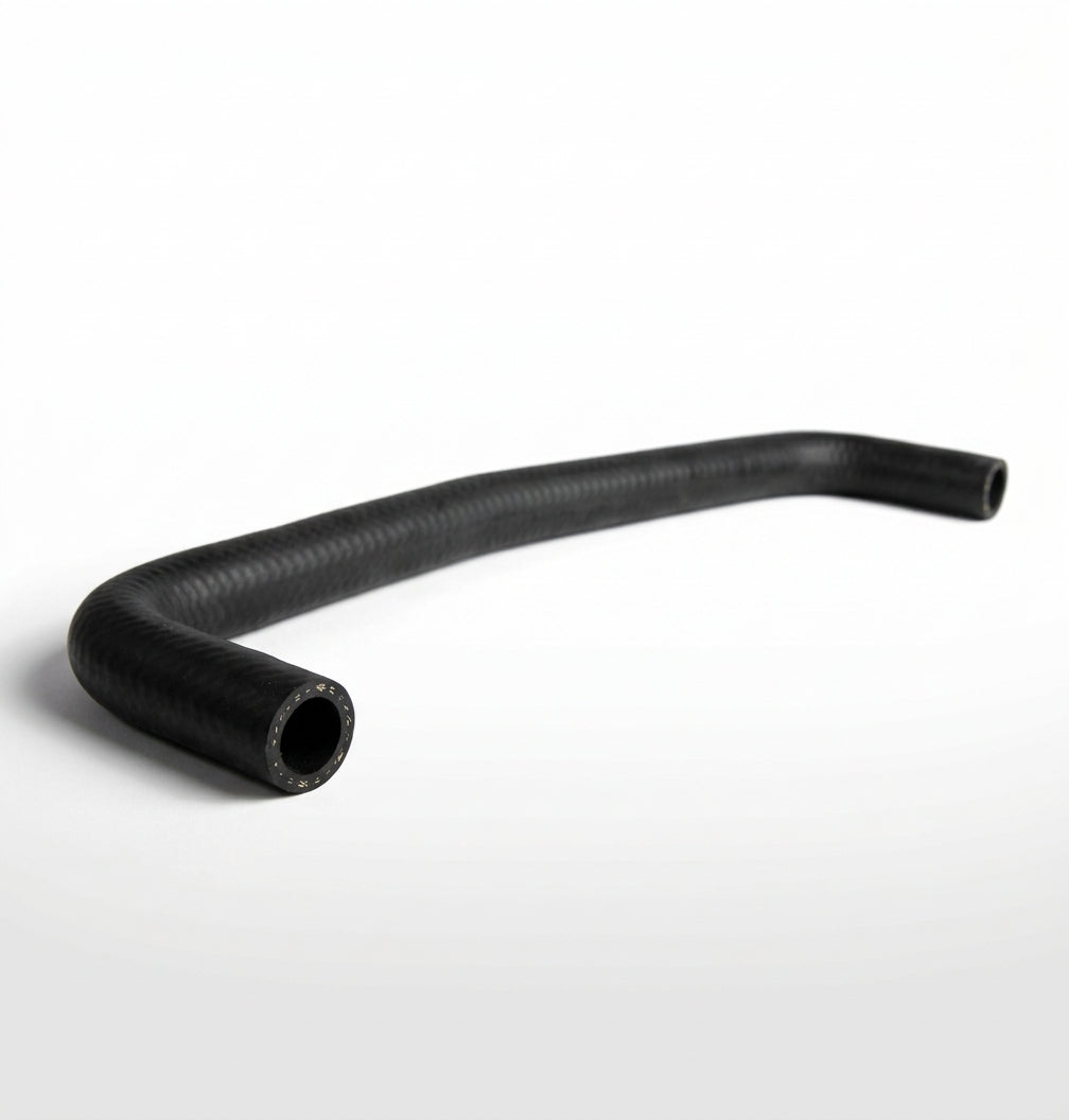 Curved black ribbed heater hose on white background, studio shot