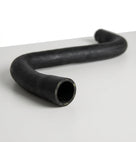 Smooth black rubber hose with an S-shaped bend, studio shot on white